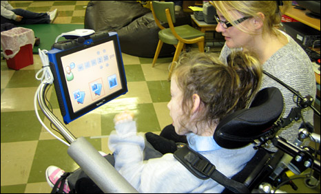Disabled child communicating with adult