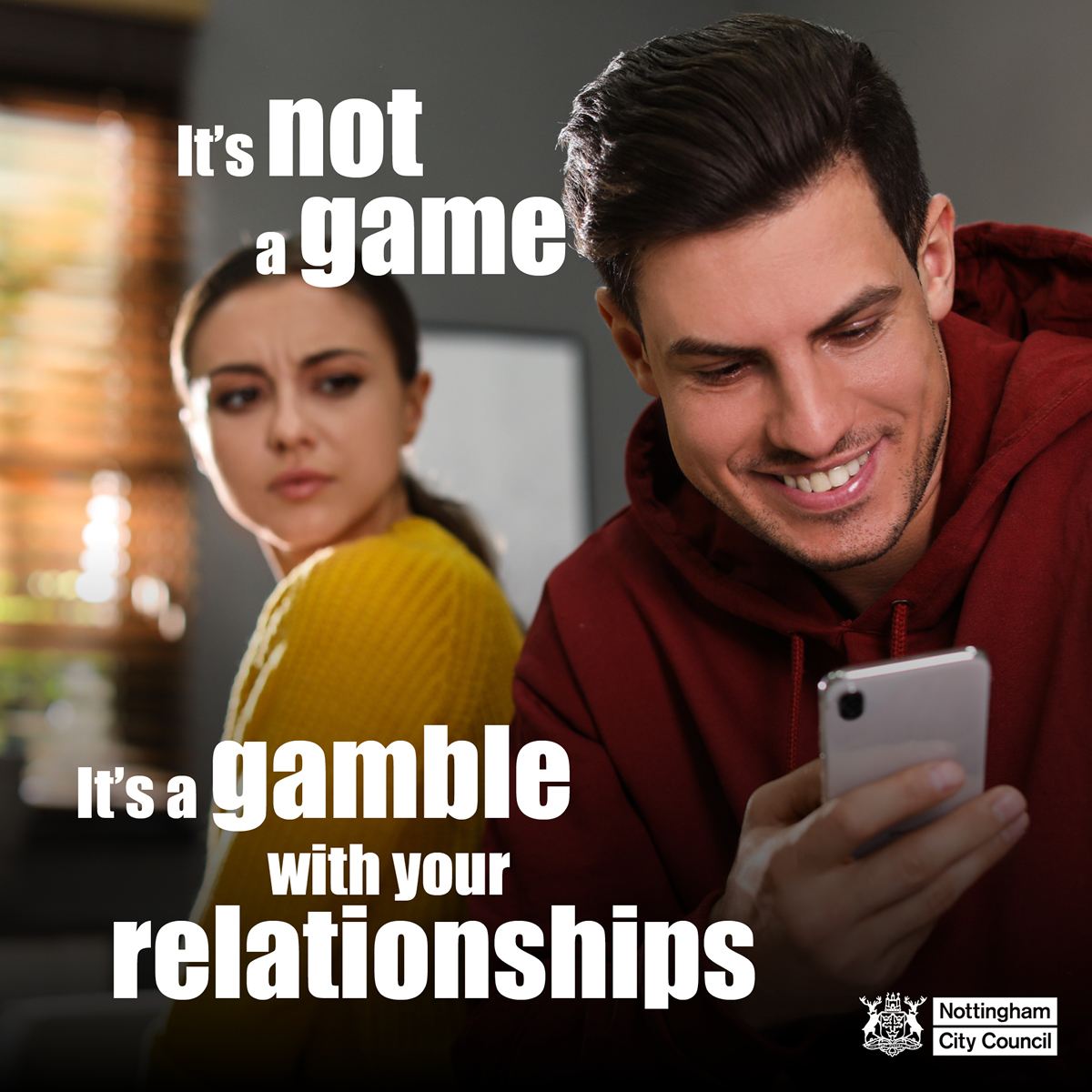 A smiling man looks at his phone while a concerned woman looks at him, with text warning gambling can harm relationships.