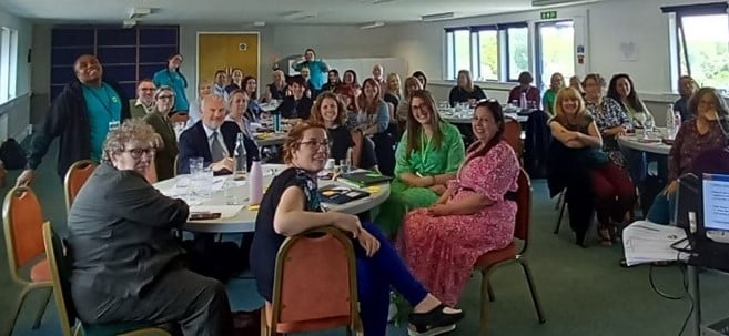 Participants sitting together at co-production event