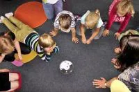 Group of children in a circle on the floor