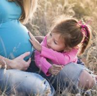 Image shows pregnant woman and child