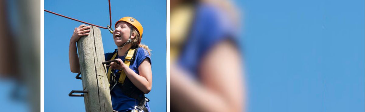 Young person climbing wearing harness and helmet