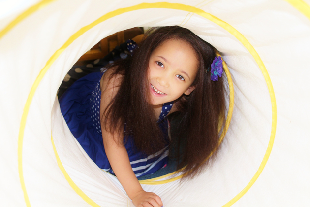 Girl in a play tunnel