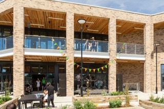 YMCA outside the cafe. Balconies and big windows create an inviting space.