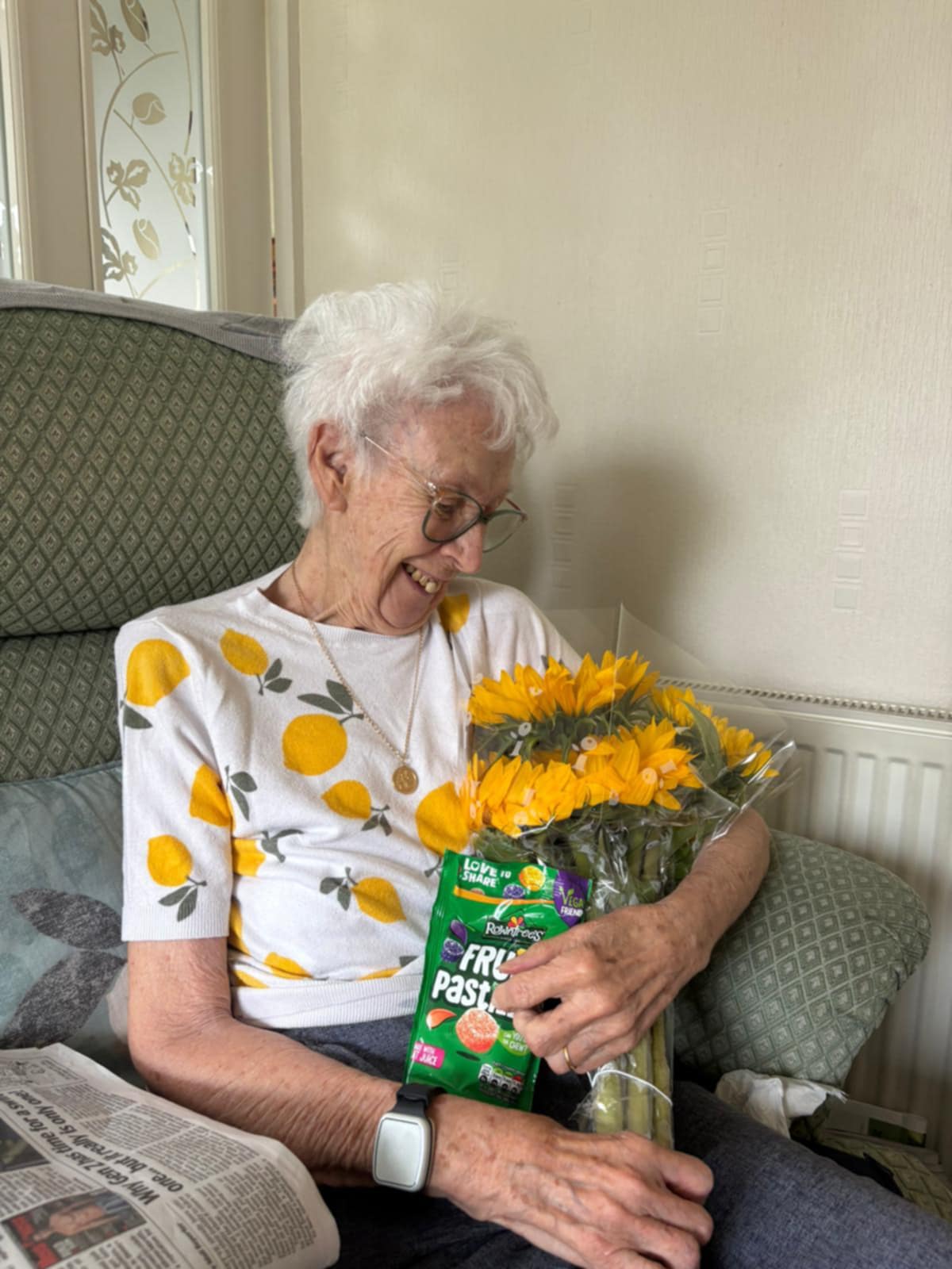 Care user with flower that our care worker gifted.