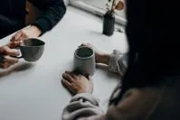 Two people sitting at table with coffee