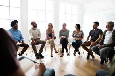 Group of eight people sitting and talking
