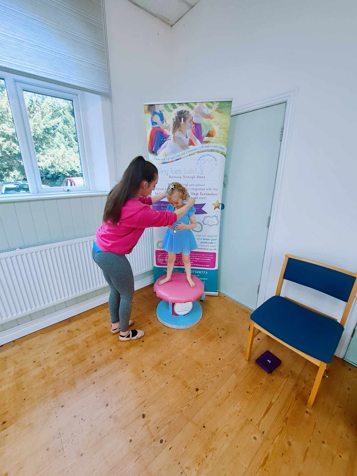 picture from a ballet session including an adult and a child