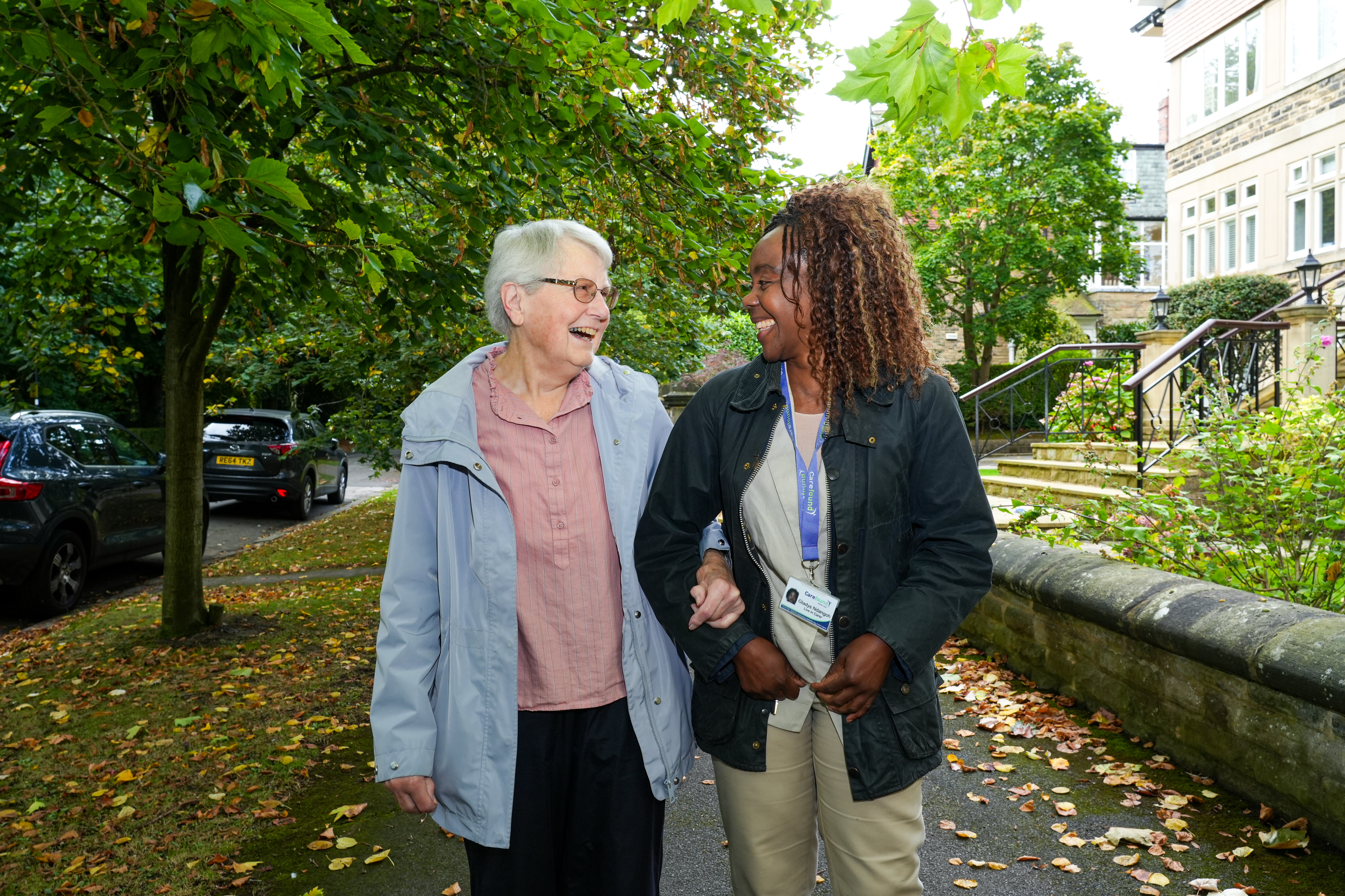 Live-in carer walking with elderly lady