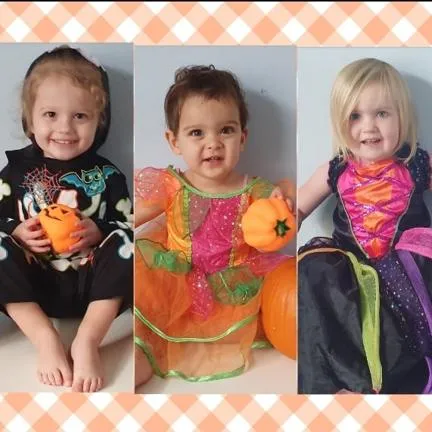 A row of five preschool children in Halloween costumes