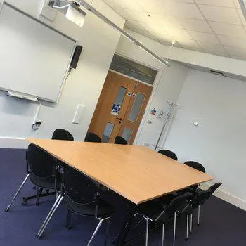 Downstairs Meeting Room
Large wooden table with surrounding chairs
