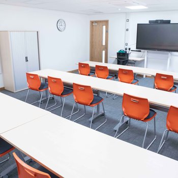 Stapleford Room 2
Bright and spacious with orange chairs and white desks. Large monitor on the far wall.