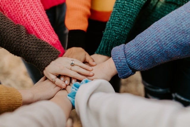 People holding hands in centre