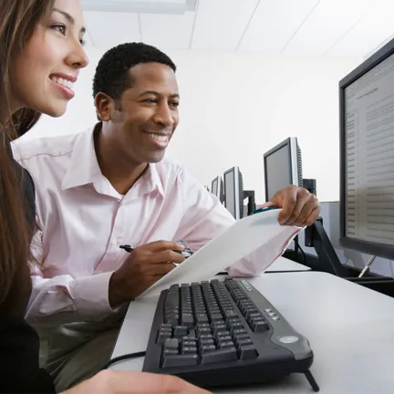Two people working at a computer