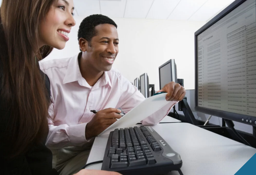 Two people working at computer