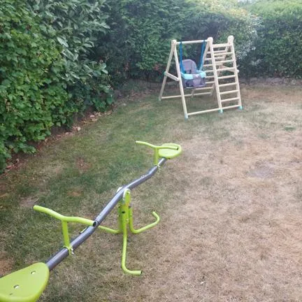 Garden with a seesaw and a swing set