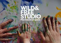 Logo for Wild and Free studio hands playing in paint